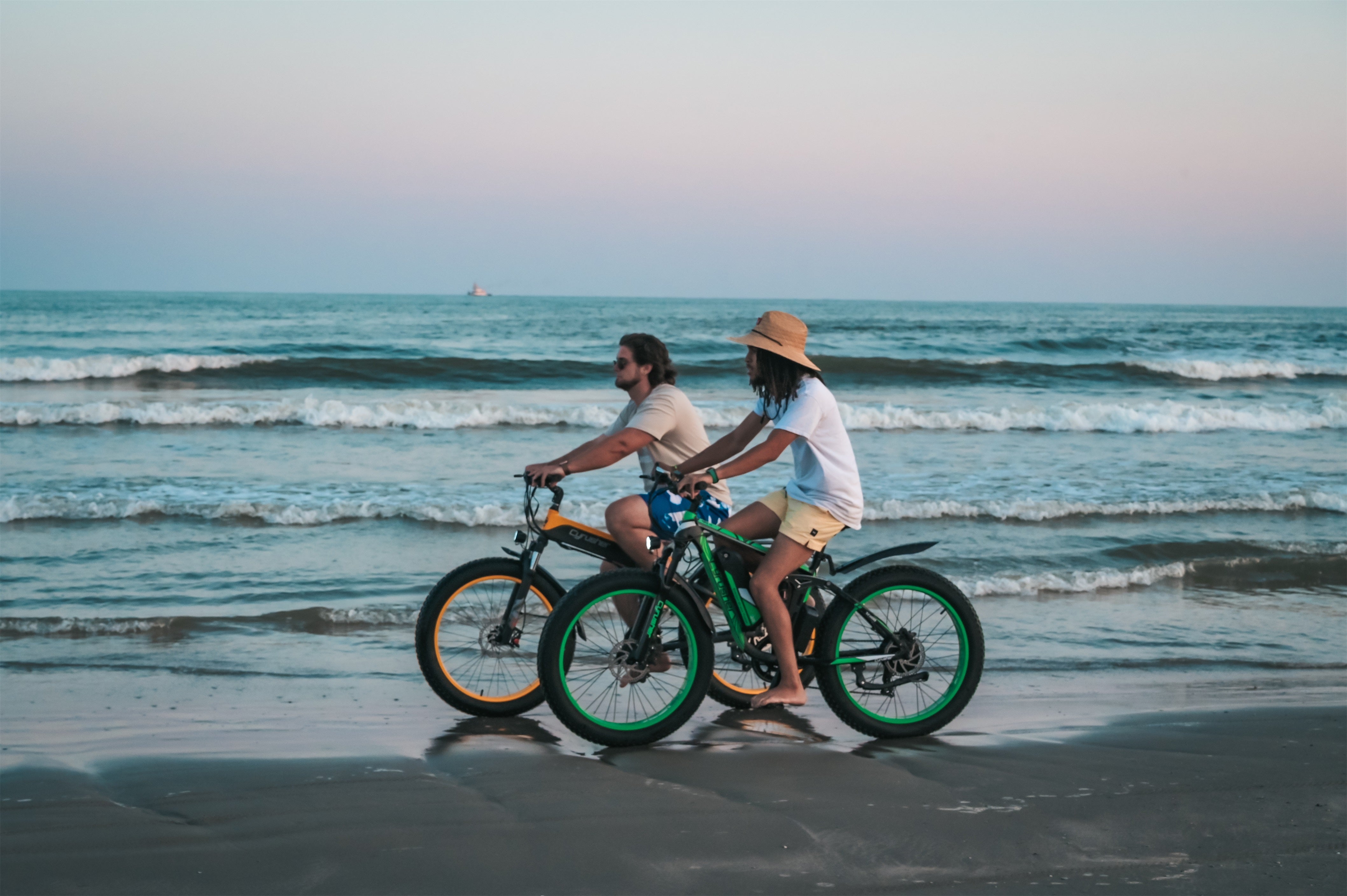 Two man riding Cyrusher ebike on the beach