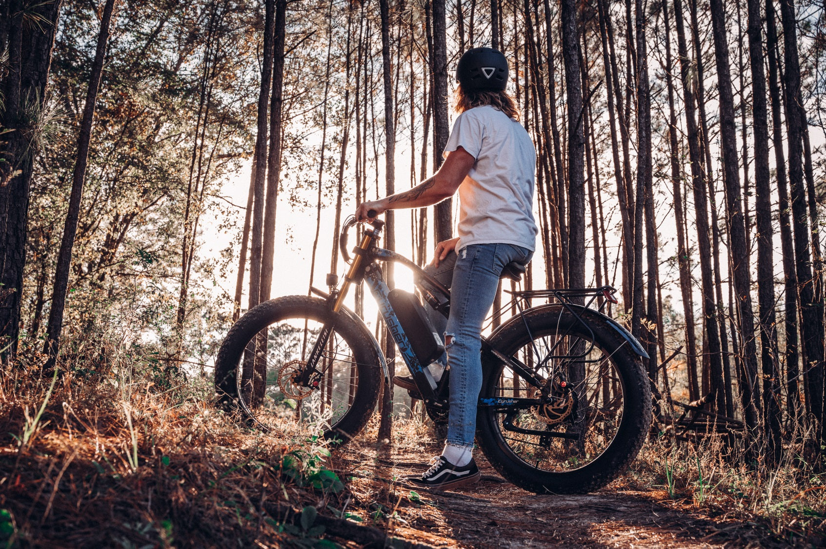 A man rides an electric bike on a mountain road