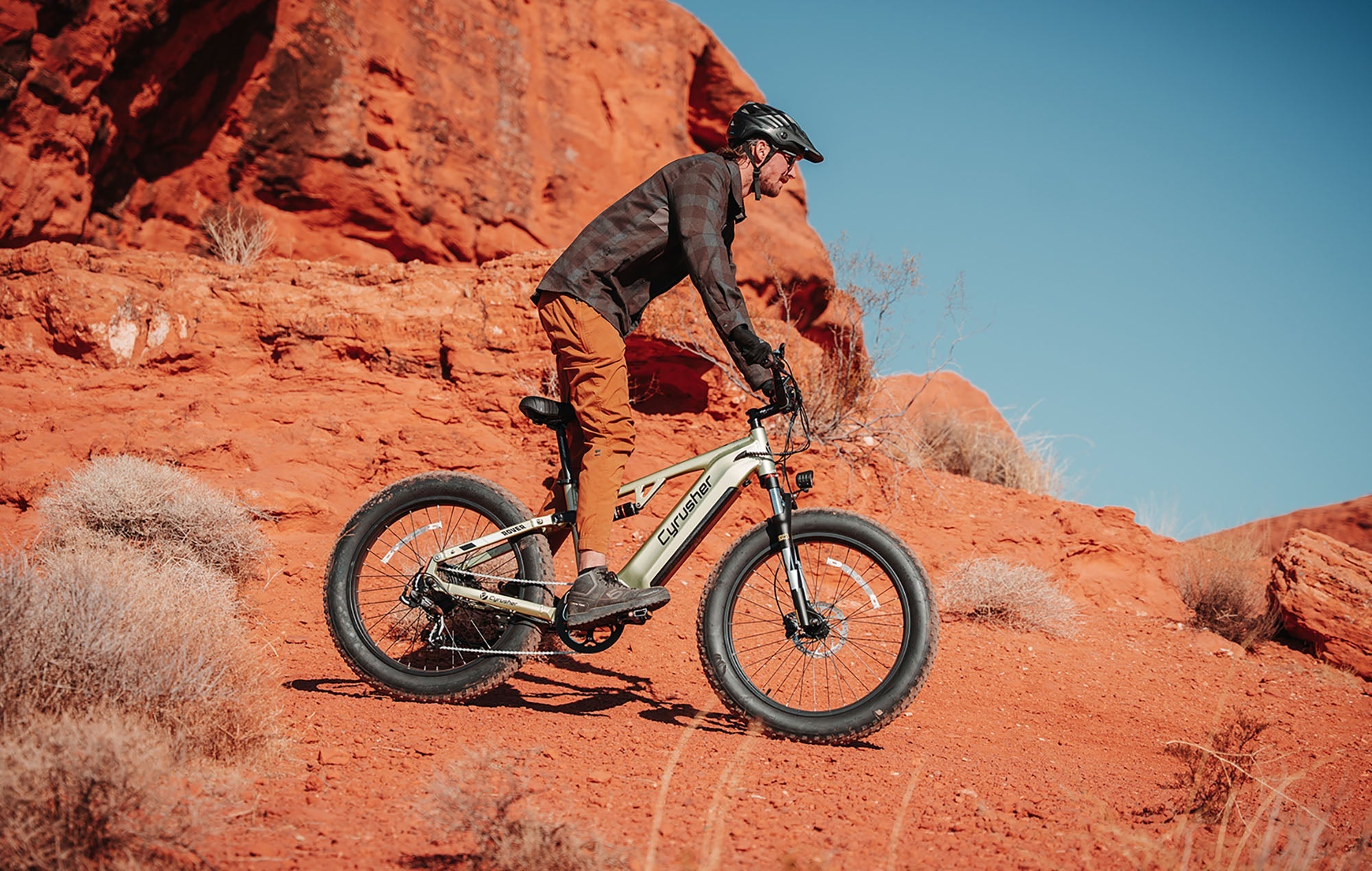 Cyrusher fat tire electric bike rider on red-rock terrain