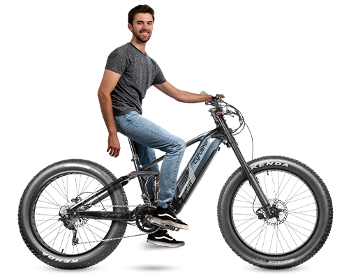 Person sitting alongside the Nitro Mountain Mid-Drive All Terrain Air Shock Ebike