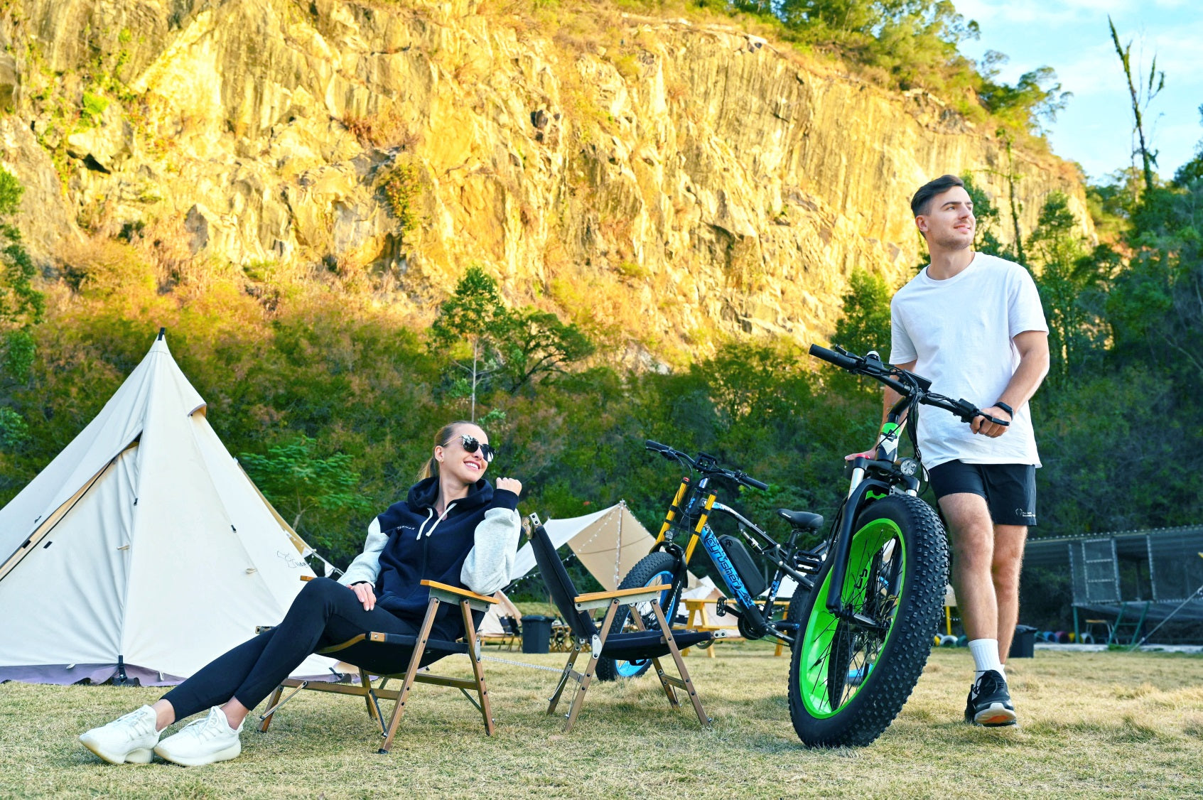 A man and a woman go camping on an electric bike