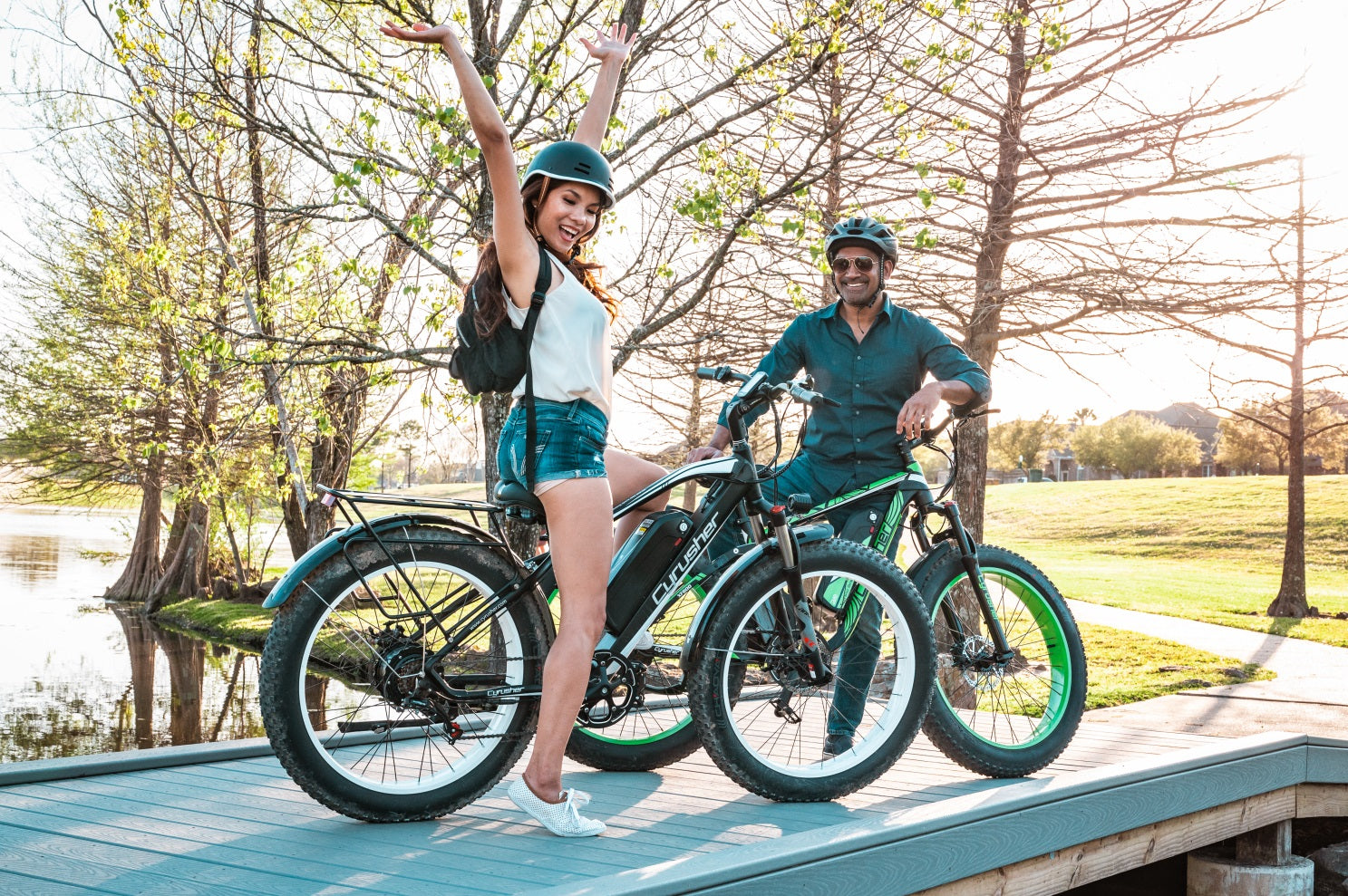 A man and a woman ride their electric bikes