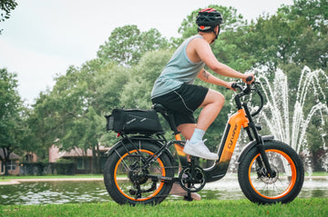 A man rides an electric bike on the grass