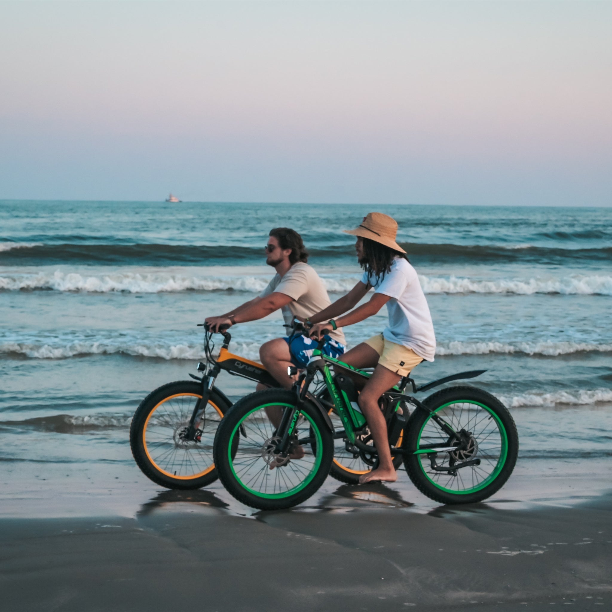 Two man riding Cyrusher ebike on the beach
