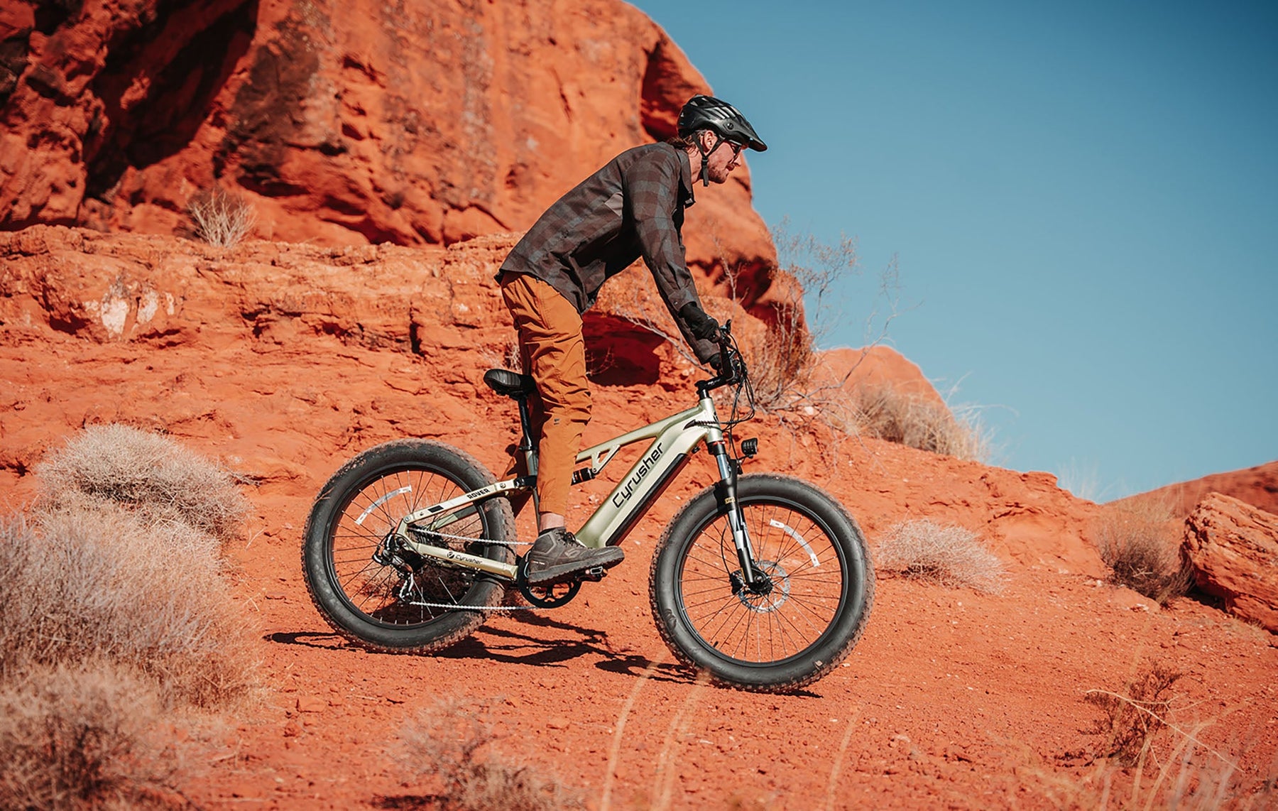 Cyrusher fat tire electric bike rider on red-rock terrain